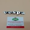 Monogramme (badge,logo) de tablier avant ( entraxe 59mm ) pour Vespa Px / Pk